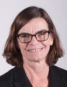 Portrait of a person with short hair on a light studio background