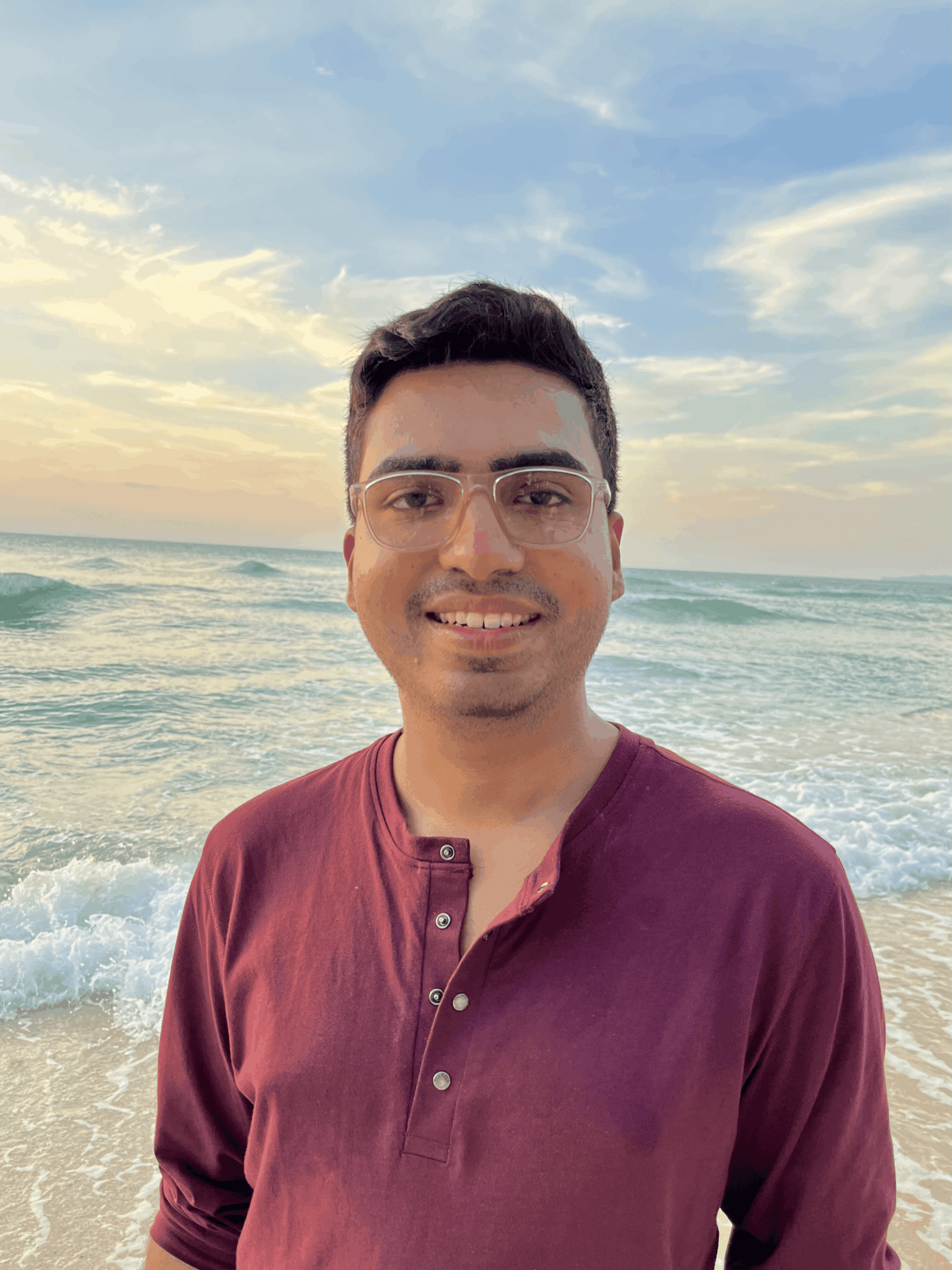 Outdoor portrait of a person in a maroon shirt with a waterfront behind