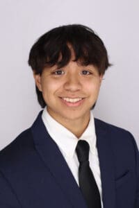 Man wearing suit smiles at the camera