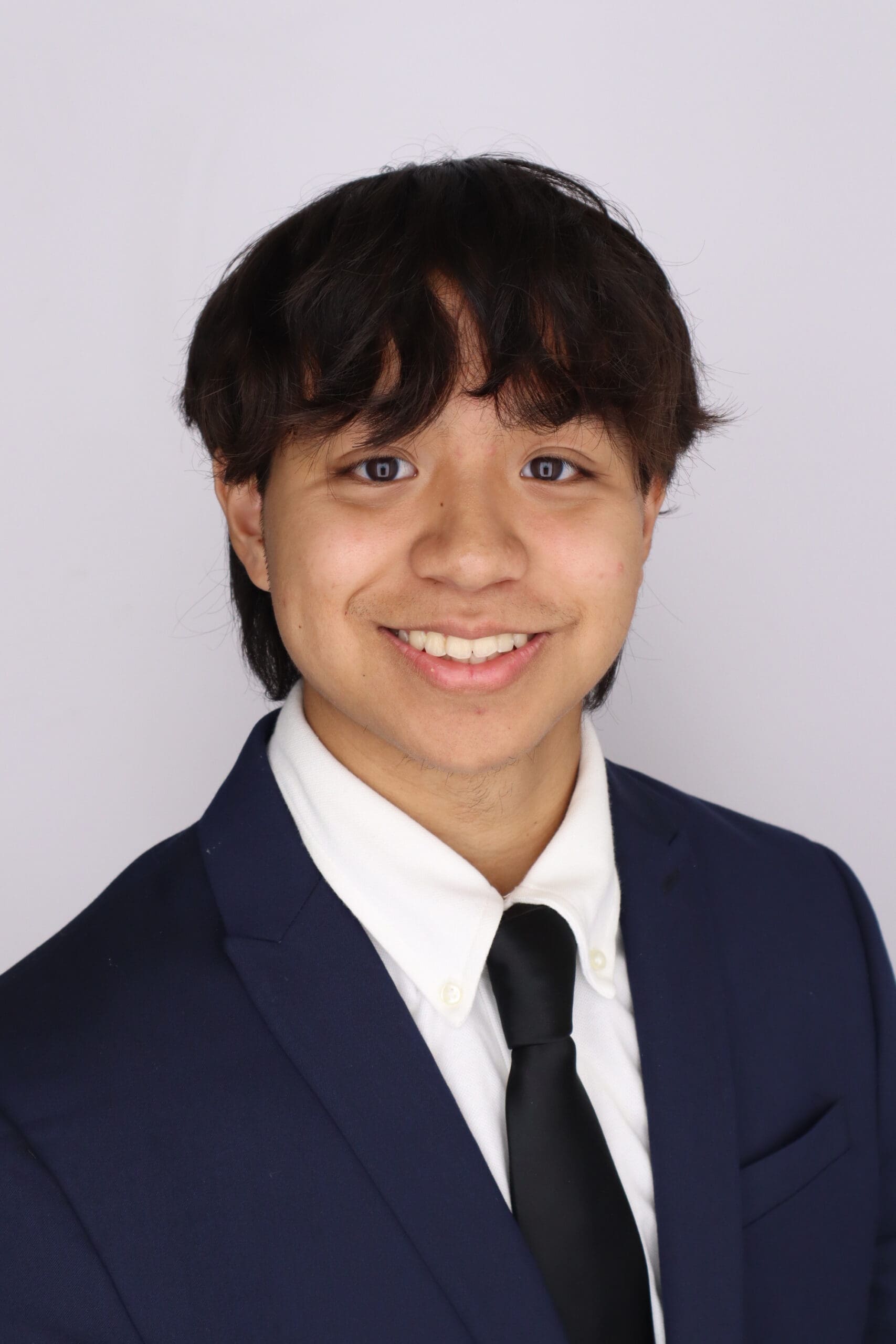 Man wearing suit smiles at the camera
