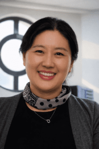 Portrait of a person wearing a patterned scarf, photographed indoors
