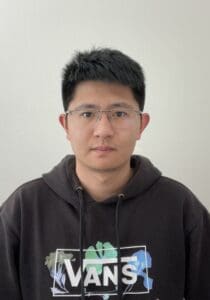 Man looking at camera, white background behind him.