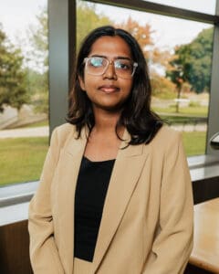 Outdoor portrait of a woman in a tan blazer.