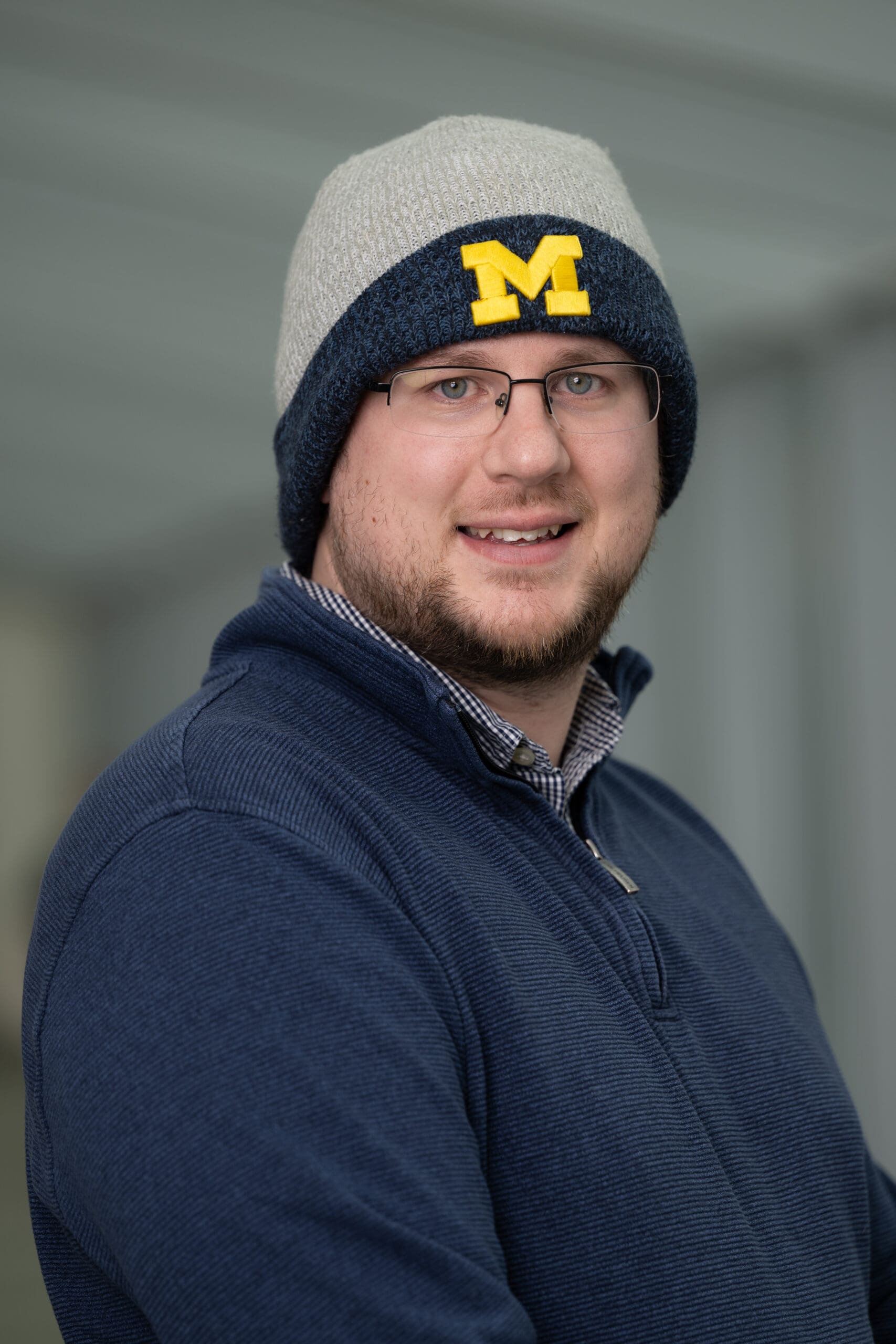 Side-profile portrait of a person in a hoodie.