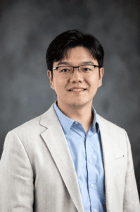 Photo of Tianming Liu in a white suit